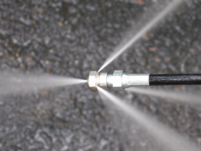 Drain-clearing hydro jetting nozzle for stubborn sewer and drain backups